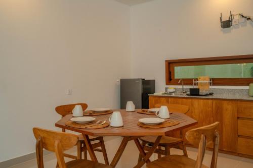 a wooden table and chairs in a kitchen at Arca Jungle View Luxury Villa Ubud in Ubud