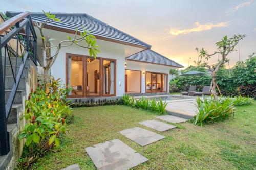 a house with a garden in front of it at Arca Jungle View Luxury Villa Ubud in Ubud