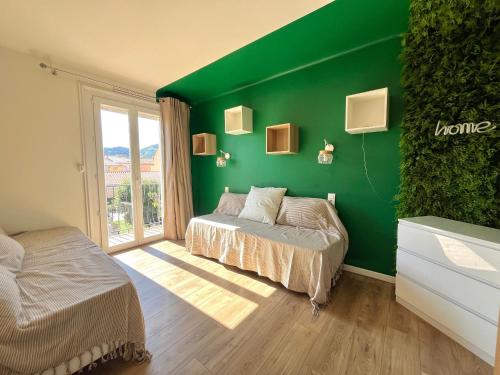 a green room with two beds and a window at Charmante maison familiale pour 10 personnes, spacieuse et confortable - FR-1-309-511 in Banyuls-sur-Mer