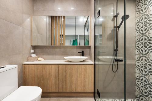 a bathroom with a sink and a shower at Luxury Gold Coast Apartment with Rooftop Terrace in Gold Coast