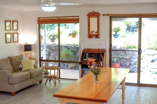 a living room with a couch and a table at Mollys Farm in Dorroughby