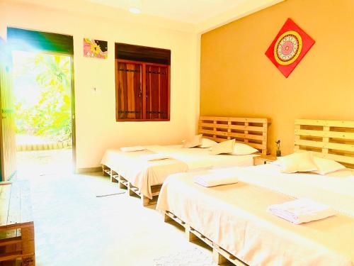 a room with three beds in a room at Inside Out Nature Villa in Kandy