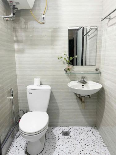 a bathroom with a toilet and a sink at Hoe Stay - Where to stay in Hanoi