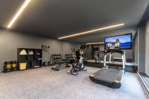 a gym with tread machines and a flat screen tv at Atour Hotel Hangzhou Xiaoshan Airport Airport Town in Hangzhou