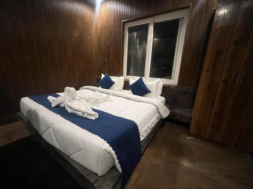 a bedroom with a large bed with towels on it at AMARJAGAT HOTEL & RESTAURANt in Rudraprayāg