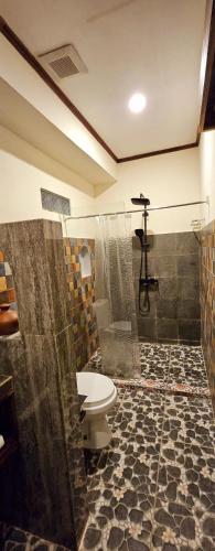 a bathroom with a shower and a toilet and a shower at Al Mare Karimunjawa in Karimunjawa