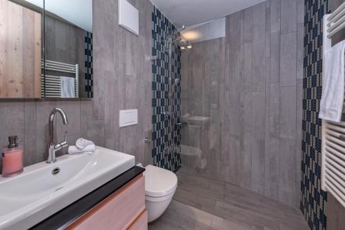 a bathroom with a sink and a toilet at Turrabuel in Parpan