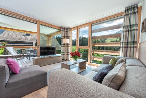 a living room with two couches and a television at Turrabuel in Parpan