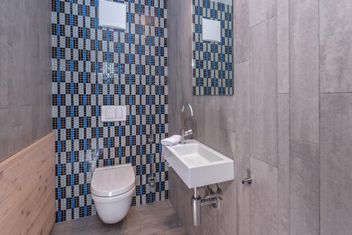 a bathroom with a toilet and a sink at Turrabuel in Parpan