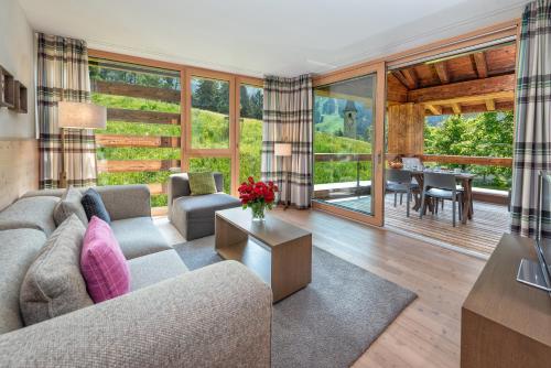 a living room with a couch and a table at Turrabuel in Parpan