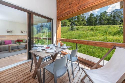 a table and chairs on the deck of a house at Turrabuel in Parpan