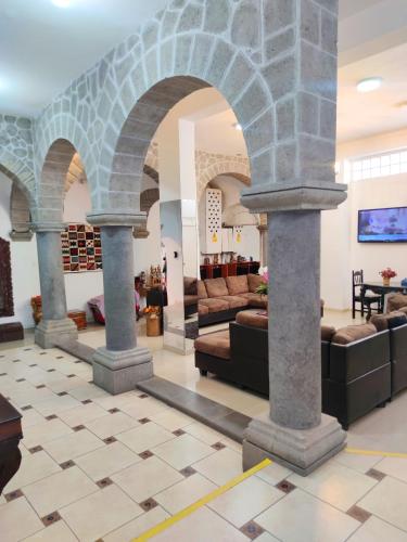 a lobby with arches and couches at Hotel San Francisco de Paula Ayacucho in Ayacucho