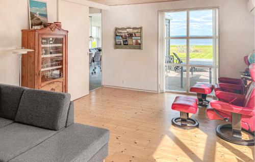 a living room with a couch and red chairs at Lovely Home In Fur With Sauna in Fur