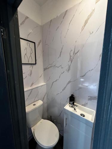 a bathroom with a white toilet and a sink at Private ensuite room close to Rotherham city centre 5 in Rotherham