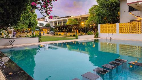 a swimming pool in front of a building at Elephant Pushkar in Pushkar