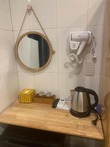 a table with a tea kettle and a mirror at Hai Dang Hotel in Can Tho