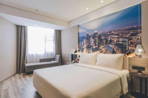 a bedroom with a large white bed and a large window at Atour Hotel Suzhou Shi Road Shantang Street in Suzhou