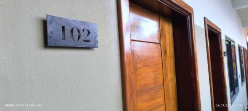 a sign on a wall next to a door at OLA LUXURY HOTEL Parakou in Parakou