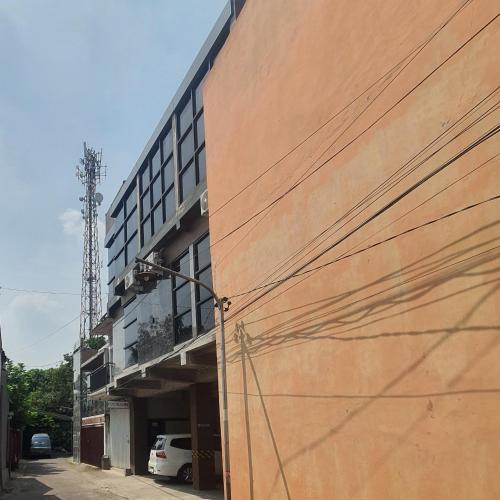 a large building with a parking garage next to it at EDUTAMA Homestay Syariah in Kediri
