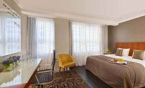 a hotel room with a bed and a desk and window at Park Plaza Nottingham in Nottingham