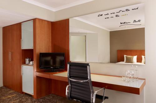 a room with a desk with a tv and a bed at Park Plaza Nottingham in Nottingham