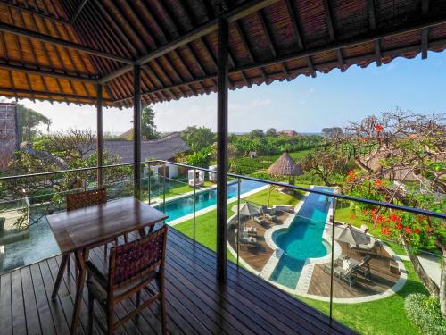 a view from the balcony of a resort with a swimming pool at The Samata by LifestyleRetreats in Sanur