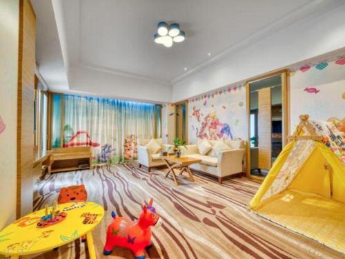 a childrens room with a play area with a slide at Xiangsheng Century Hotel Zhuji in Shaoxing