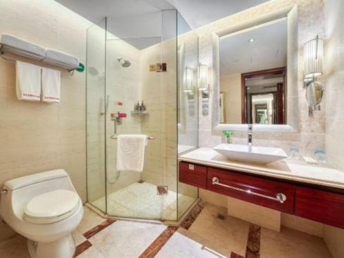 a bathroom with a toilet and a sink and a shower at Xiangsheng Century Hotel Zhuji in Shaoxing