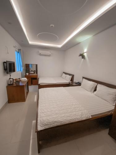 Postel nebo postele na pokoji v ubytování Mio Hotel Vũng Tàu
