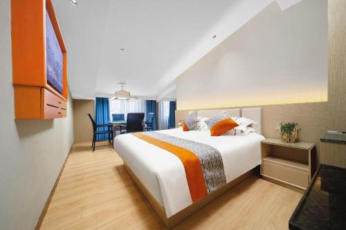 a hotel room with a large bed and a table at JIAN AI XI YUE HOTEL in Yiwu