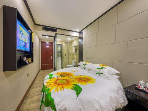 a bedroom with a bed with sunflowers on it at JIAN AI XI YUE HOTEL in Yiwu