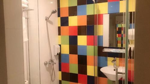a colorful bathroom with a shower and a sink at Shanghai Jiejia hotel in Shanghai