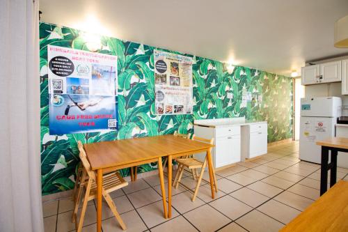 a kitchen with a wooden table in a room at Waikiki Beachside Hostel in Honolulu