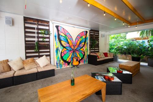 a living room with a butterfly painting on the wall at Waikiki Beachside Hostel in Honolulu