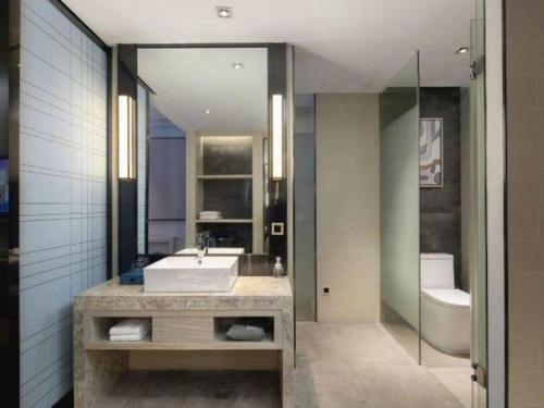 a bathroom with a sink and a large mirror at Echarm Hotel Changsha High-speed Railway Station in Changsha