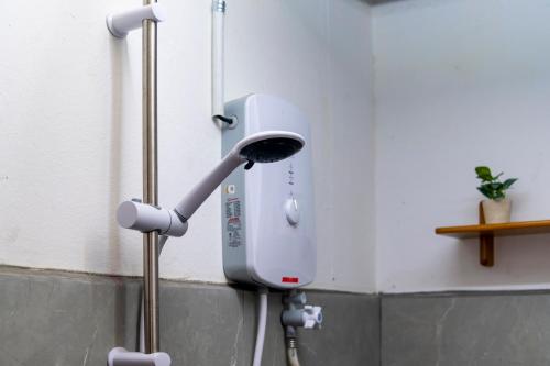 a hair dryer is attached to a wall at Aru corner 6B1BR Tanjung aru town kota kinabalu in Kota Kinabalu