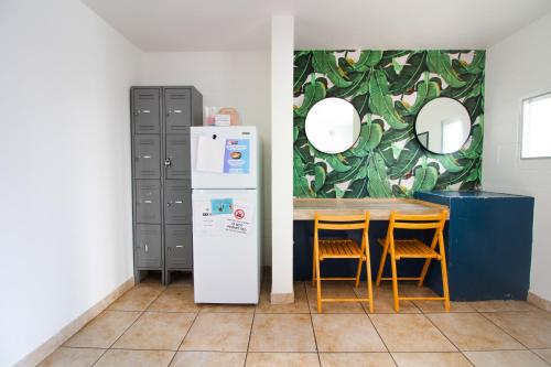 a dining room with a table and a refrigerator at Waikiki Beachside Hostel in Honolulu