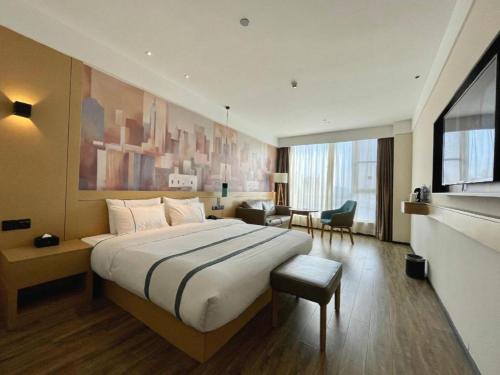a bedroom with a large bed in a hotel room at City Comfort Inn Nantong Qidong Renmin Zhong Road Xingfudao in Huilongzhen