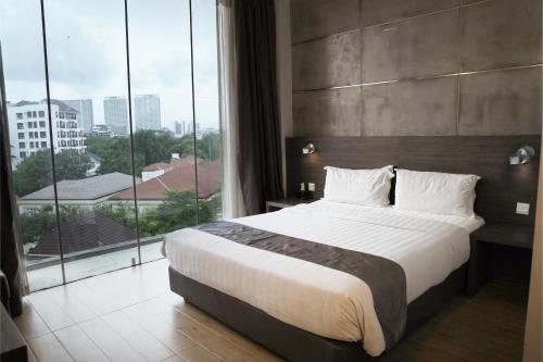 Postel nebo postele na pokoji v ubytování Dreamtel Jakarta