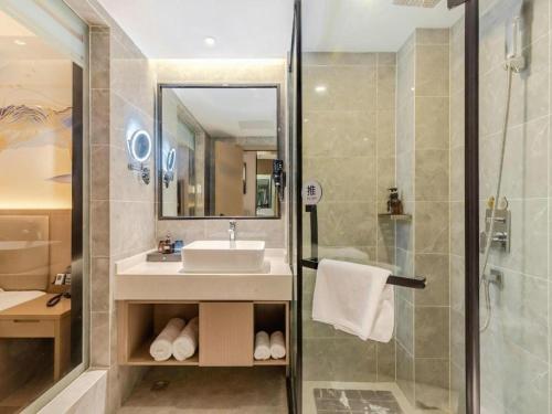 a bathroom with a sink and a shower at GreenTree Eastern Hotel Chizhou Tonghui Plaza in Chizhou