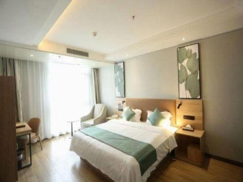 a hotel room with a large bed and a window at GreenTree Inn Anqing Yingbin Dong Road High-Speed Railway Station in Anqing