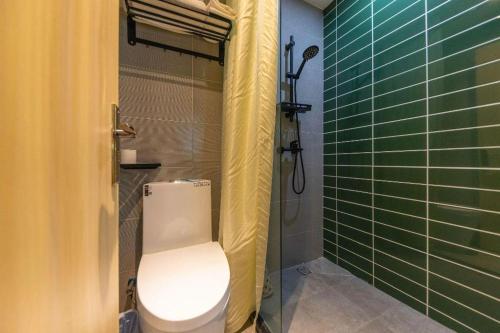 a bathroom with a toilet and a shower at GreenTree Inn Express Lanzhou West Passenger Station Lanzhou Center in Lanzhou