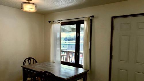a dining room with a table and a window at Captain's Quarters - Reduced Price Tours! in Mendenhaven