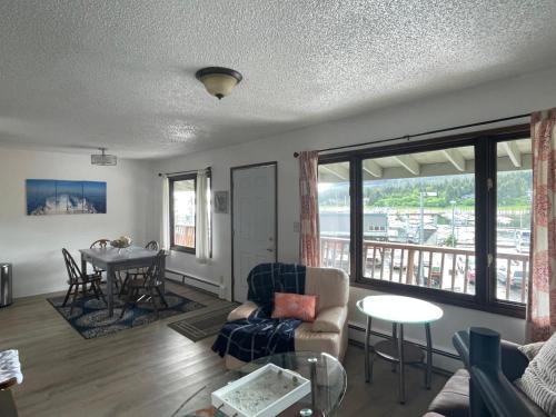 a living room with a couch and a table at Captain's Quarters - Reduced Price Tours! in Mendenhaven