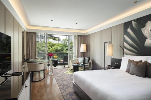 a hotel room with a bed and a desk at Siam Kempinski Hotel Bangkok in Bangkok