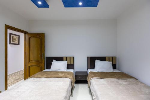 Ένα ή περισσότερα κρεβάτια σε δωμάτιο στο Pyramids Yard Hotel
