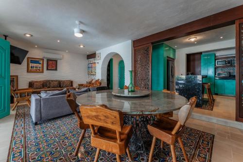 a living room with a table and a couch at La Casa Del Velero, Beachfront in Chicxulub