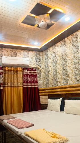 a bedroom with a bed and a window with curtains at vaidehi homlee premium stay, 3kms from Shri Ram janmbhoomi, Ayodhya in Faizābād