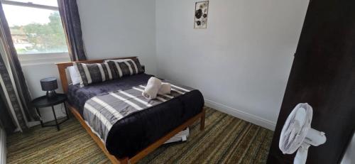 a small bedroom with a bed and a window at National Smokehouse Hotel Coleraine in Coleraine