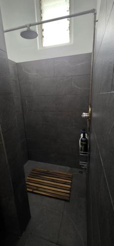 a bathroom with a shower with a window at National Smokehouse Hotel Coleraine in Coleraine